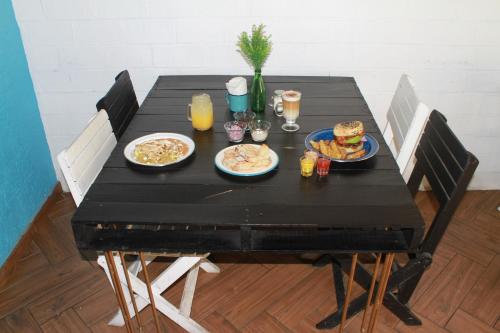 a black table with plates of food and drinks at Hotel La Casona de Don Jorge in Colima