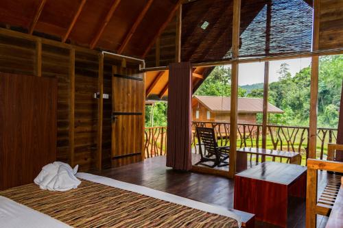 a bedroom with a bed and a table and a window at Kandy Cabana in Kandy