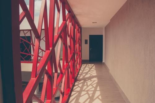 a hallway with red dividers on a wall at Remfort Hotel in Santa Ana