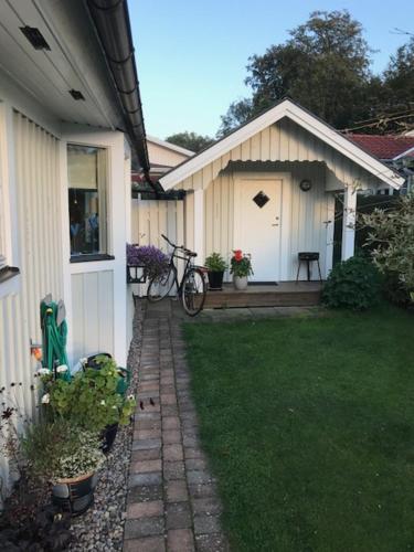 a house with a bike parked in front of it at Badstugan in Karlshamn