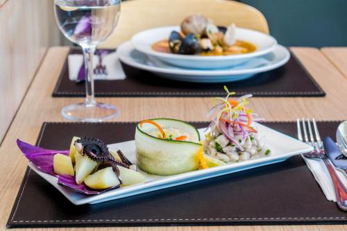 a table with a plate of food on a table at ibis Calama in Calama
