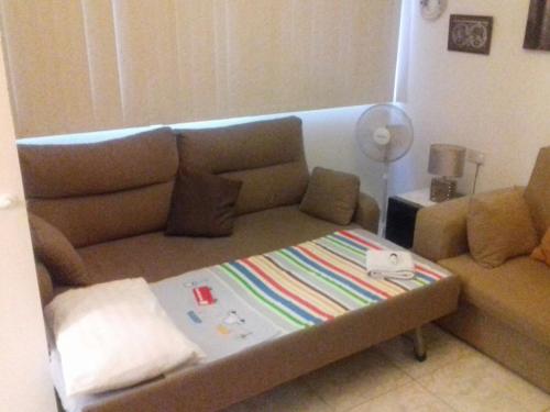 a living room with a couch and a table at Arcadia 408 in Gibraltar
