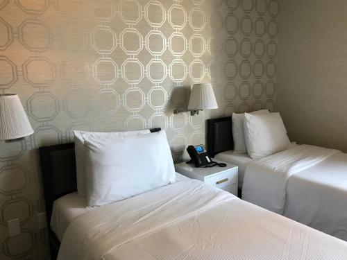 Una cama o camas en una habitación de Hotel Mimosa