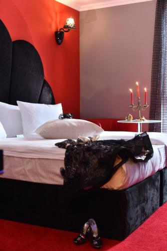 a bedroom with a bed with a dress on it at Best Boutique Hotel in Stara Zagora