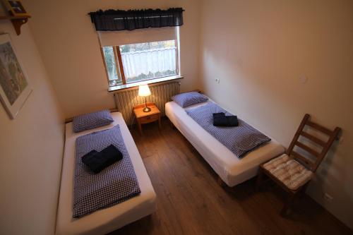 an overhead view of a bedroom with two beds and a window at CJA Guesthouse in Laugar