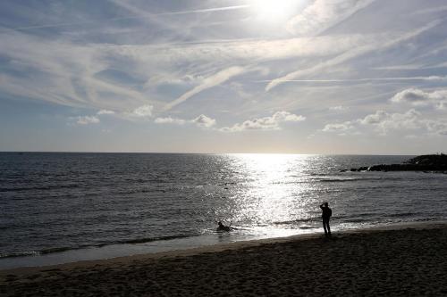 a person standing on a beach near the ocean at B&B Rifugio San Francesco in Lido di Ostia