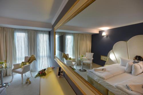 a bedroom with a large mirror and a bed at Best Boutique Hotel in Stara Zagora