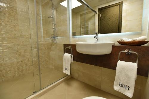 a bathroom with a sink and a glass shower at Best Boutique Hotel in Stara Zagora