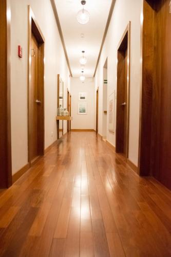 an empty hallway with wooden floors and doors at Los Brezos Hotel Boutique in Volcán