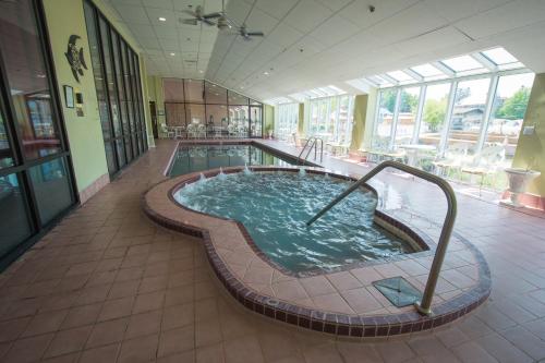 a large swimming pool in a building with a pool at Riveredge Resort Hotel in Alexandria Bay