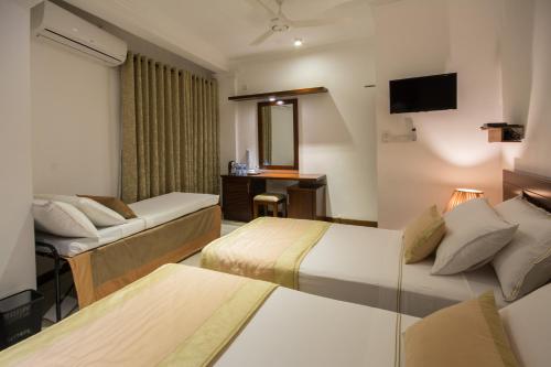 Ceyloni City Hotelにあるベッド
