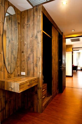a room with a mirror and a wooden wall at Samed Pavilion Resort in Ko Samed