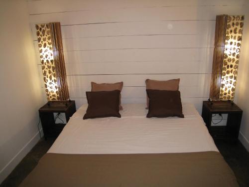 מיטה או מיטות בחדר ב-La Case des Caraïbes