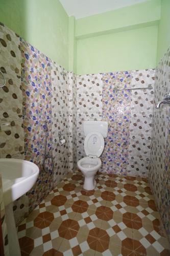 a bathroom with a toilet and a sink at Harry Guest House & Restaurant in Pokhara