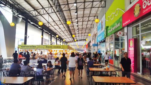 a group of people walking through a shopping mall at Popular Condo by Jintana in Pak Kret