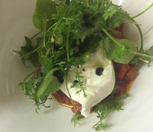 a plate of food with greens on top at Gasthof OHR in Eisenstadt