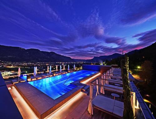 a pool on the roof of a building at night at Giardino Marling in Merano