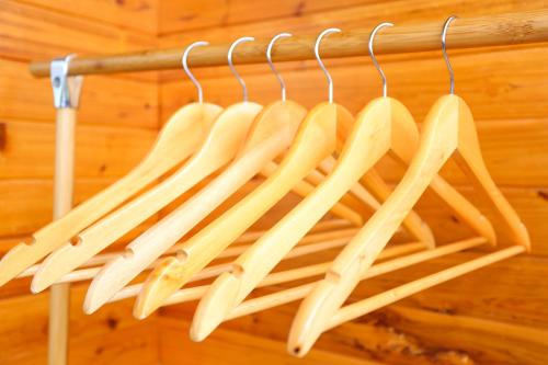 a bunch of wooden utensils hanging on a rack at Ridge Inn in Longsheng