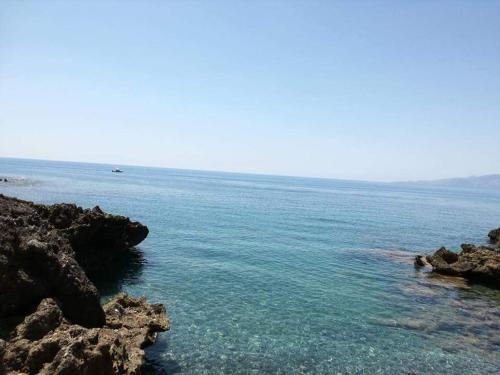 a body of water with rocks and the ocean at Zia Yaya in Maratea