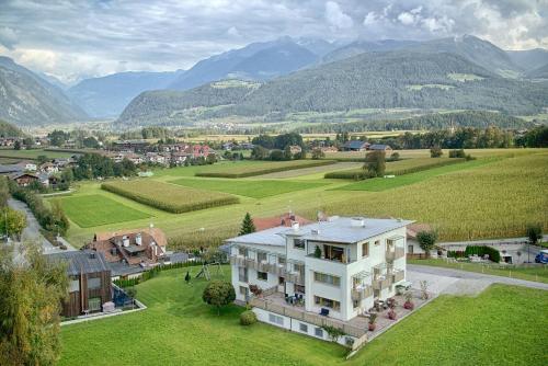 an aerial view of a house with mountains in the background at B&B Garni Schorneck in Brunico