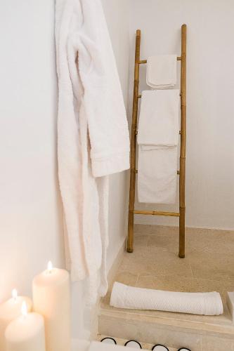 a room with a towel and candles and a chair at S'Hotelet d'es Born - Suites & SPA in Ciutadella