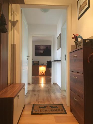 a hallway with a living room with a fireplace at FeWo s Runde Wiese RW in Greifswald