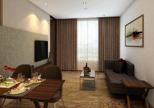 a living room with a couch and a table at Sayaji Vadodara in Vadodara