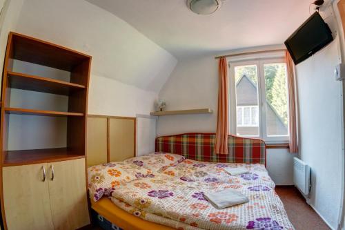 a small bedroom with a bed and a window at Chata Špindlerův Mlýn 256 in Špindlerův Mlýn