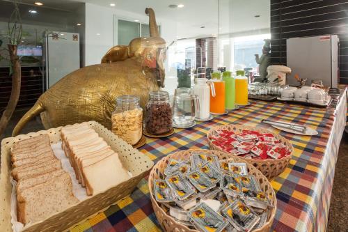 a table with bread and other food items on it at Armoni Patong Beach Hotel in Patong Beach