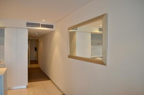 a hallway of a house with a mirror on the wall at APTonNorthTCE in Adelaide