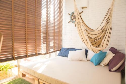a bed in a room with a hanging hammock at Marlicante in Alicante