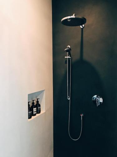 a bathroom with a shower with a shower head at AVLiving City INSIDE NINE Basel in Basel