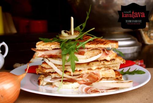 a sandwich cut in half on a white plate at Angel Main Square Center Zagreb in Zagreb