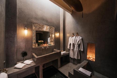 a bathroom with a sink and a mirror at Riad Azzar in Marrakesh