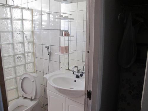 a white bathroom with a toilet and a sink at Guesthouse Sharon Aarhus in Aarhus