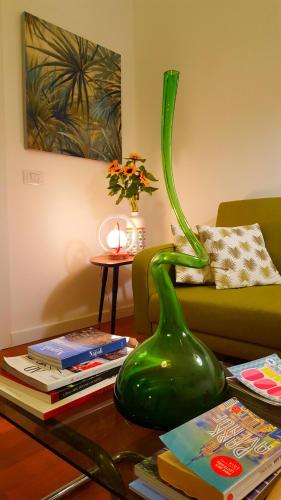 a green vase sitting on a table in a living room at Napoli Tree - Lungomare in Naples