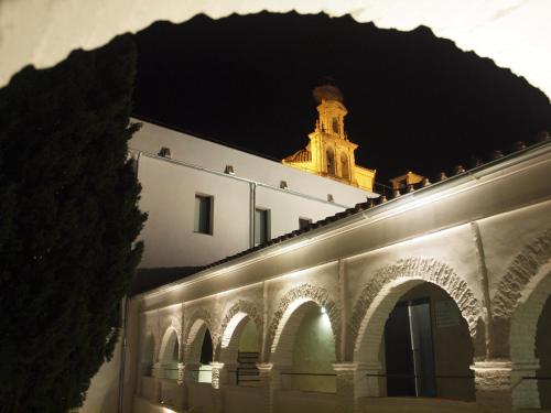 a building with a clock tower in the background at Hotel Convento Aracena & SPA in Aracena