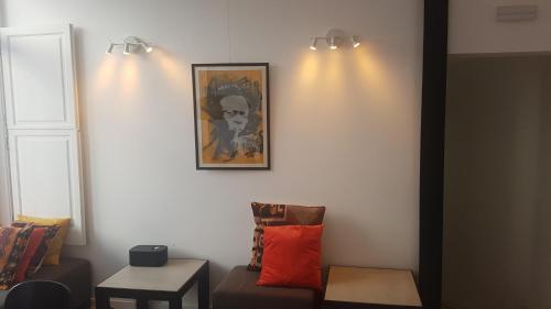 a living room with a couch and a picture on the wall at Tings Lisbon in Lisbon