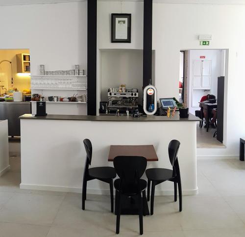 a kitchen with a table and chairs and a counter at Tings Lisbon in Lisbon