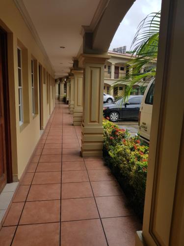 a hallway of a building with columns and flowers at Hotel Florencia in San Miguel