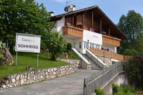 a house with a sign in front of it at Garni Sonnegg in Petersberg