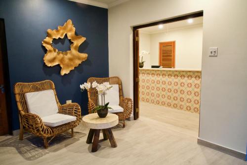 a room with two chairs and a table and a mirror at White Sands Negril in Negril