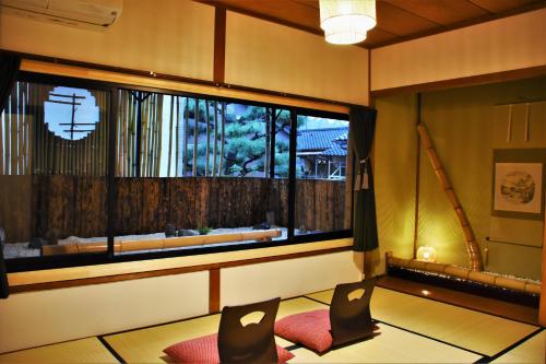 
a living room with a table and a window at Guest House Oumi in Kyoto
