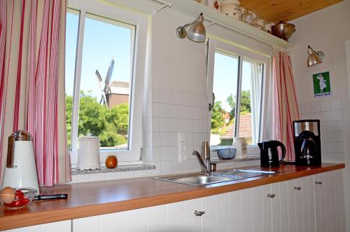 a kitchen with a sink and a window at Am Inselufer in Werder