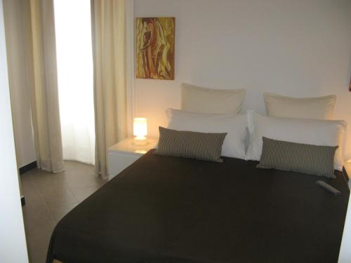 a bedroom with a black and white bed with two pillows at iBed Napoli B&B in Naples