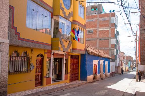 a colorful building on a street in cuba at Hotel T'ika in Puno