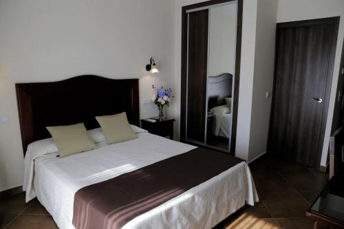 a bedroom with a bed and a dresser at Arcos de Montemar in Torremolinos