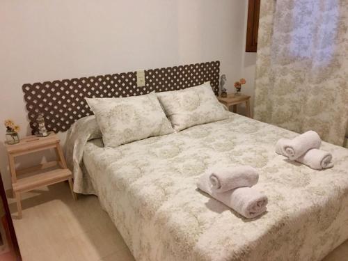a bedroom with a bed with towels on it at Royal Garden Santa Clara in Jávea