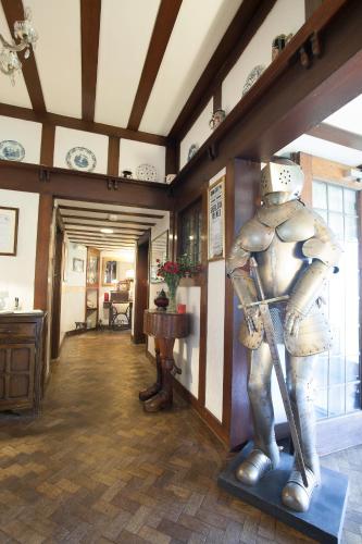 a room with a statue of a man with a spear at Barons Court Hotel in Wolverhampton