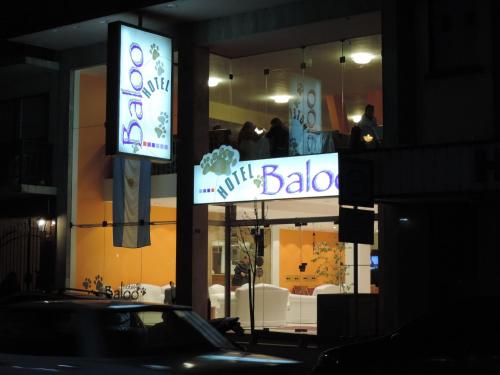 a sign for a baby store on a street at night at BALOO Hotel in Mar del Plata